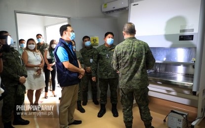 <p><strong>COVID-19 MOLECULAR LAB.</strong> Army commander, Lt. Gen. Gilbert Gapay (right), and DOH Assistant Secretary Nestor Santiago (in blue vest), lead the launching of the Army's Covid-19 molecular laboratory in Fort Bonifacio, Taguig City on Tuesday (July 28, 2020). The laboratory aims to provide quality and accurate health care services related to emerging infectious diseases to Army personnel, military dependents, civilian employees, and other authorized civilians in the Army. <em>(Photo courtesy of the Army Chief Public Affairs Office)</em></p>