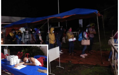 <p><strong>DAY AND NIGHT DUTY.</strong> Returning residents queue up as they arrive at the North Cotabato Provincial Capitol receiving area after they were fetched by members of the province’s Task Force Sagip via the Davao City airport. A front-liner (inset) takes a nap while awaiting LSIs who arrived in Kidapawan City at 10 p.m. on Wednesday (July 29, 2020). <em>(Photo courtesy of North Cotabato PIO)</em></p>