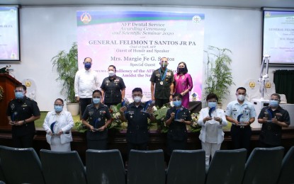 <p><strong>AWARDEES.</strong> AFP Chief of Staff, Gen. Felimon Santos Jr., (2nd from right, back row), poses with this year's awardees during the celebration of the 66th anniversary of the AFP Dental Service at the National Defense College Auditorium in Camp Aguinaldo on Thursday (July 30, 2020). Santos said the AFP Dental Service continues to prove its critical role in promoting oral and dental health among soldiers and civilian personnel. <em>(Photo courtesy of the AFP Public Affairs Office)</em></p>