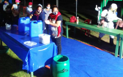 <p><strong>FINALLY HOME</strong>. Returning locally stranded individuals wash their hands as they arrive Saturday night (Aug. 1, 2020) in one of the two decontamination areas at the North Cotabato provincial capitol grounds in Amas, Kidapawan City. After complying with health protocols, they will be sent to their respective localities for more health preventive measures before they are reunited with their families. <em>(Photo courtesy of North Cotabato PIO)</em></p>