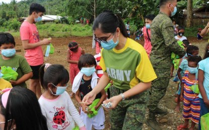 <p><strong>CARING FOR THE CHILDREN.</strong> Members of the youth group, Propelling Our Inheritance Nation Through Youth Inc. (POINTY), and government troops under the Army's 30th Infantry Battalion conducts outreach on the  Mamanwa children in Sitio Landing, Barangay Camam-onan, Gigaquit, Surigao del Norte, on Aug. 1, 2020. The children received 153 sets of facemasks and hygiene kits. <em>(Photo courtesy of 30IB)</em></p>