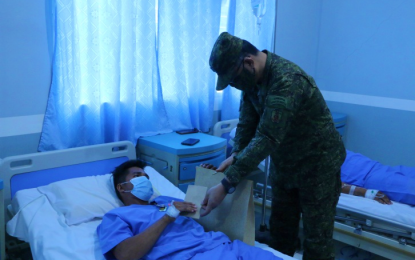 <p><strong>HEROIC ACTS.</strong> Major Gen. Diosdado Carreon, the Army’s 6th Infantry Division commander and chief of Joint Task Force Central, pins a medal and gave financial assistance to an injured infantryman during the awarding of wounded personnel medals at the Camp Siongco Station Hospital in Awang, Datu Odin Sinsuat, Maguindanao on Sunday (August 2, 2020). Nine other wounded Army personnel were awarded medals for displaying bravery in the fight against the Daesh-inspired Bangsamoro Islamic Freedom Fighters in the province. <em>(Photo courtesy of 6ID)</em></p>