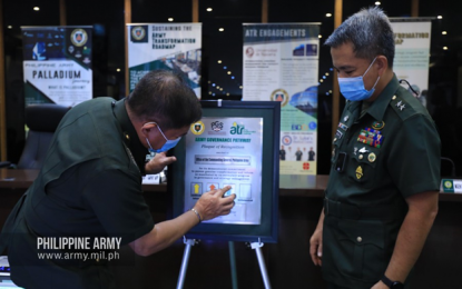 <p><strong>'PROFICIENT' STATUS.</strong> Former Army commander and now Armed Forces of the Philippines chief-of-staff, Lt. Gen. Gilbert Gapay (left) pins the Proficient Status medallion on the Army's Office of the Commanding General’s Army Governance Pathway (AGP) plaque in Fort Bonifacio, Taguig City on Tuesday (Aug. 4, 2020). The Army Governance Pathway aims to promote the core values, mission, and vision of the Army as it pioneers initiatives of change and good governance. <em>(Photo courtesy of the Army Chief Public Affairs Office)</em></p>