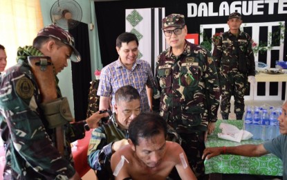 <p><strong>MEDICAL MISSION</strong>. A reservist doctor performs minor surgical operation during a medical mission in Dalaguete, Cebu in 2018 as Brig. Gen. Erik Miguel Espina, chief of 1901st Infantry Brigade Ready Reserve (right), and Mayor Alan Cesante (in civilian shirt) look on. Espina on Tuesday (August 4, 2020) said he is pushing for issuance of Annual Active Duty Training (AADT) for the reservists who will answer the call of President Rodrigo Duterte to serve in the front line battle against Covid-19. <em>(File photo courtesy of 1901st Infantry Brigade Ready Reserve)</em></p>