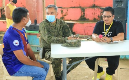 <p><strong>STRONG IP COMMUNITIES.</strong> Lt. Col. Julius Cesar C. Paulo (center), commander of the Army's 23rd Infantry Battalion, and Datu Bawang Eddie Eddie Sulhayan Ampiyawan (left), the Indigenous People Mandatory Representative of Agusan del Norte, join the dialogue initiated by Sec. Allen Capuyan, of the National Commission on Indigenous People, and the National Task Force to End Local Communist Armed Conflict, with the tribal communities in Agusan del Norte on Aug. 4, 2020. <em>(Photo courtesy of 23IB)</em></p>