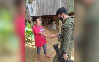 <p><strong>ABANDONING NPA</strong>. A soldier shakes hand with Baby Senobio in San Francisco, Las Navas, Northern Samar in this August 5, 2020 photo shared by the Philippine Army. The military lauded her for abandoning the communist ideology and taking part in peace efforts in their village. <em>(Photo courtesy of Philippine Army 20th Infantry Battalion)</em></p>