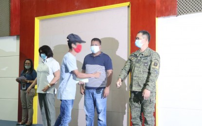 <p><strong>AID FOR EX-REBELS.</strong> A former member of the communist New People"s Army receives financial assistance from the officials of the province of  Davao de Oro provincial government and the Philippine Army on Tuesday (August 4, 2020). Each former rebel got PHP10,000 cash while they are waiting for other benefits under the Enhanced Comprehensive Local Integration Program. <em>(Photo courtesy of Davao de Oro PIO)</em></p>