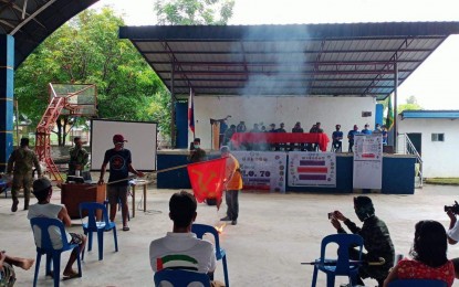 <p><strong>TORCHING THE REBEL FLAG</strong>. Former supporters of the New People’s Army (NPA) set fire to the rebel group’s flag in Barangay Siclong Laur, Nueva Ecija after they reaffirmed their support for the government on Friday (Aug. 7, 2020). Some 304 former NPA supporters pledged to reject any form of intrusion by the communist rebels in their communities. <em>(Photo courtesy of the Army's 91st Infantry Battalion)</em></p>