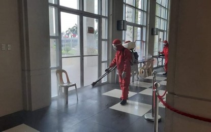 <p><strong>DISINFECTION.</strong> Personnel of the City Disaster Risk Reduction Management Office fumigate the lobby of the Bacolod City Government Center (BCGC) in early August. Starting Monday noon (Aug. 10, 2020), the BCGC has been locked down for at least seven days after a second city government employee succumbed to Covid-19. <em>(File photo courtesy of Bacolod City DRRMO)</em></p>