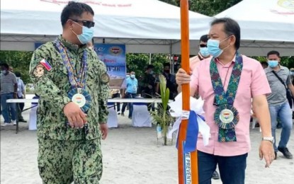 <p><strong>TASK FORCE.</strong> Brig. Gen. Jesus Cambay Jr., Police Regional Office-9 director, hands over a paddle to Zamboanga del Sur Gov. Victor Yu during the launching of the Task Force Pink Panther on Monday (Aug. 10, 2020) in Tukuran, Zamboanga del Sur. The task force aims to boost security in 'risk areas' and address threat groups in the region. <em>(Photo courtesy of the Zamboanga del Sur Provincial Press Bureau)</em></p>