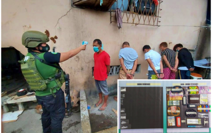 <p><strong>ARRESTED.</strong> An anti-narcotics agent checks the body temperature of one of five drug suspects arrested during a buy-bust operation in an alleged drug den in Barangay Poblacion 2, Cotabato City on Thursday (Aug. 13, 2020). Seized from the suspects (inset) were some PHP102,000 worth of suspected shabu and other pieces of evidence. <em>(Photo courtesy of PDEA-BARMM)</em></p>
