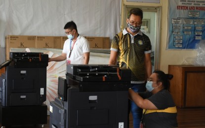 <p><strong>MODULE PRINTERS</strong>. Department of Education personnel inspect the new photocopiers donated by the Borongan City government on Monday (Aug. 17, 2020). The machine will print learning materials of students during the health crisis. <em>(Photo courtesy of Borongan City information office)</em></p>