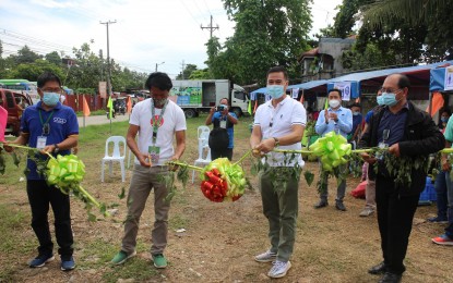 <p><strong>MOBILE MARKET.</strong> Department of Agriculture (DA-7) Executive Regional Director Salvador Diputado (3rd from left) leads the ribbon-cutting ceremony during the opening of the Kadiwa People's Market in Lapu-Lapu City on Tuesday (Aug. 28, 2020). The mobile market that brings fresh farm produce closer to the consumers is operated by the Cebu People's Multi-Purpose Cooperative, in partnership with the DA-Central Visayas.<em> (Photo courtesy of DA-7)</em></p>