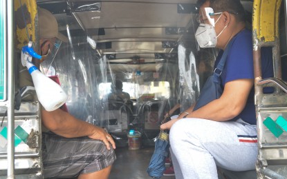 <p><strong>SAFE JEEPNEY RIDE. </strong>Passengers wearing face masks and shields inside a traditional jeepney. To ensure continued economic activity in the midst of the Covid-19 pandemic, the government required several safety protocols for operators, drivers, and passengers of public transportation. (<em>PNA file photo</em>)  </p>