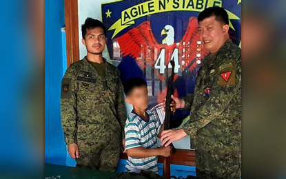 <p><strong>SURRENDERERS.</strong> Five communist New People's Army rebels surrender on Aug. 18, 2020 to the Army's 102nd Infantry Brigade in the Zamboanga Peninsula. In the photo is Ka Pawpaw, one of the five NPA surrenderers, handing over a rifle to Lt. Col. Don Templonuevo, commander of the 44th Infantry Battalion based in the Zamboanga Sibugay town of Imelda. <em>(Photo courtesy of the 44IB)</em></p>