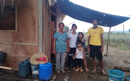 <p>Romeo Demaymay, with his wife and grandchildren, pose in front of their humble home in Jabonga, Agusan del Norte. Having less in life did not prevent Manong Romeo’s family to make a difference in other people’s lives. <em>(DSWD photo)</em></p>