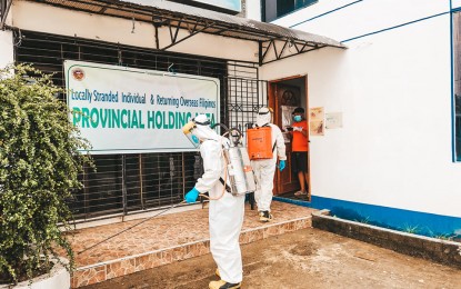 <p><strong>DISINFECTION</strong>. Personnel of the Bureau of Fire Protection (BFP) disinfect the holding area for returning residents in Catarman, Northern Samar on August 17, 2020. The Department of Health on Wednesday (Aug. 26, 2020) reported 115 new coronavirus disease 2019 cases in Eastern Visayas, bringing the region’s total to 2,363. <em>(Photo courtesy of BFP Catarman)</em></p>