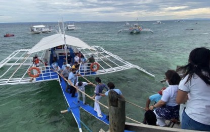<p><strong>REOPENING TOURISM</strong>. Tourists hop on a motorbanca to enjoy island-hopping in Cordova town. Mayor Maria Theresa Sitoy-Cho on Monday (Aug. 31, 2020) said her town re-opened its tourism industry amid the lower quarantine classification in Cebu. <em>(Photo courtesy of Municipality of Cordova PIO)</em></p>