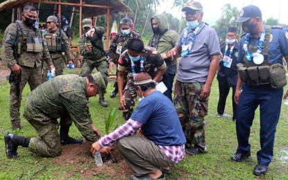 <p><strong>REORIENTATION SEMINAR.</strong> Military, police, and Moro National Liberation Front (MNLF) officials plant a coconut seedling after the culmination of a 20-day reorientation seminar for the MNLF's defense forces in Barangay Napulan, Sirawai, Zamboanga del Norte on Thursday (Sept. 3, 2020. The seminar was attended by 70 MNLF members from different barangays in Sirawai town. <em>(Photo courtesy of the 1st Infantry Division Public Affairs Office)</em></p>