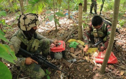 <p><strong>ABANDONED REBEL LAIR.</strong> Army troopers recover various parts of high-power firearms and other supplies in an abandoned hideout of the communist New People’s Army on Sept. 5, 2020 in a forested area of Mt. Indocay, Sitio Bulak, Barangay Lower Olave in Buenavista, Agusan del Norte. The military says the discovery was made possible by civilian tip-offs.<em> (Photo courtesy of 23IB)</em></p>