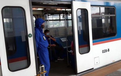 <p><strong>MRT SECURITY</strong>. A security guard wearing personal protective equipment waits for passengers to board at the doors of the MRT-3 at Quezon Avenue in Quezon City on Tuesday (September 8, 2020). The MRT management has deployed security personnel to ensure that health protocols are observed amid the coronavirus pandemic.<em> (PNA photo by Jess Escaros Jr)</em></p>