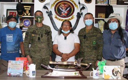 <p><strong>PEACE, DEVELOPMENT.</strong> Lt. Col. Franco Raphael Alano, commander of the Army's 55th Infantry Battalion (2nd from right), and Bangsamoro Transition Authority member Adbullah Macapaar, who is also one of the leaders of the Moro Islamic Liberation Front (center), talk about peace and development in Lanao del Sur in a meeting Tuesday (Sept. 8, 2020). After the meeting, the two joined the other officials in a photo session in Camp Bilal in Tamparan, Munai, Lanao del Sur. <em>(Photo courtesy of the 1st Infantry Division Public Affairs Office)</em></p>