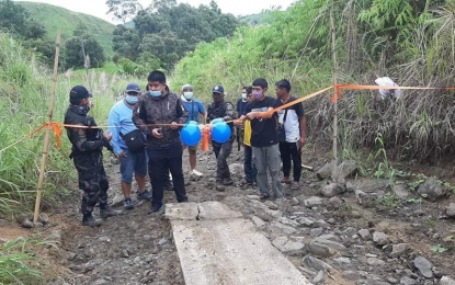 <p><strong>PEACE PROJECTS.</strong> Kiblawan Mayor Jason Rama leads the ribbon-cutting during the turnover ceremony for the 150-meter concrete pathway road in Barangay Abnate, Kiblawan town, Davao del Sur, on Wednesday (September 16, 2020). The project was initiated by the police and the military,  through the Revitalized Police Sa Barangay and Retooled Community Support Program. <em>(Photo courtesy of the Davao del Sur Provincial Police Office)</em></p>