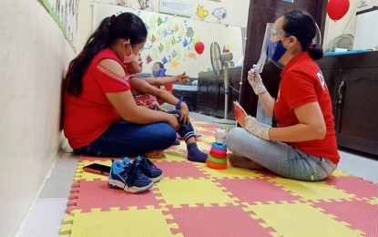 <p><strong>CEREBRAL PALSY AWARENESS WEEK.</strong> Physical therapist Angie Liz Vagilidad (right) conducts therapy session to a four-year at the Community Based Inclusive Development Unit Therapy Center of the Provincial Government in San Jose de Buenavista last July. The Antique provincial government through the Provincial Social Welfare and Development Office is now celebrating the 17th Cerebral Palsy Awareness and Protection Week. <em>(File photo courtesy of Antique PSWDO-PDAO)</em></p>
