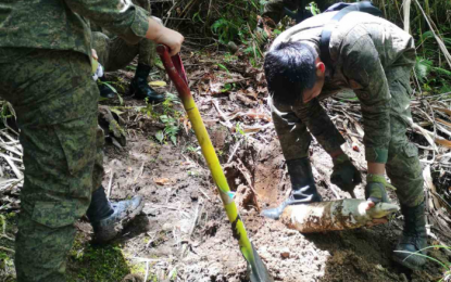 <p><strong>RETRIEVED.</strong> Soldiers and bomb experts try to extricate unexploded ammunition of 105mm howitzer in a remote village in Bagumbayan, Sultan Kudarat on Thursday (Sept. 17, 2020). The cannon ammunition was discovered by a farmer who reported the matter to soldiers of the 7th Infantry Battalion in the area. <em>(Photo courtesy of 6ID)</em></p>