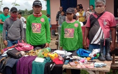 <p><strong>INTERCEPTED</strong>. Authorities arrest two New People's Army rebels (in green sweatshirts) Monday (Sept. 21, 2020) in Midsalip town, Zamboanga del Sur. The pair fled from firefight between the rebels and government forces in Dumingag town, officials say. <em>(Photo courtesy by Western Mindanao Command Public Information Office)</em></p>