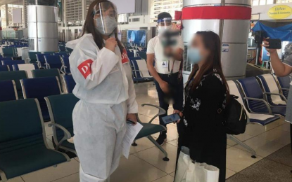 <p><strong>FINALLY HOME</strong>. Overseas Filipino worker Rose Policarpio (right) gets instruction from Department of Foreign Affairs personnel upon her arrival at the Ninoy Aquino International Airport on Tuesday (Sept. 22, 2020). Policarpio was once on death row for allegedly committing murder in Saudi Arabia. <em>(Photo by DFA)</em></p>