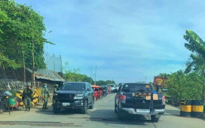 <p><strong>ON ALERT.</strong> Government troopers check on vehicles entering and leaving Ampatuan, Maguindanao following the capture of a Bangsamoro Islamic Freedom Fighter lair in remote Barangay Saniag of the municipality on Tuesday (Sept. 22, 2020). An alert status has been raised in the area due to anticipated retaliatory attacks from the terror group after a number of its followers were killed in ongoing military operations in the province. <em>(Photo courtesy of PNA Cotabato)</em></p>