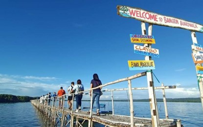 <p><strong>BANGRIN MARINE PROTECTED AREA</strong>. Residents cross the one-kilometer boardwalk going to the mangrove forest at the Bangrin Marine Protected Area in Bani town in Pangasinan. The town has opened the area to local residents starting Sept. 18, 2020. <em>(Photo courtesy of Bani Tourism Facebook page)</em></p>