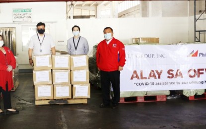 <p><strong>DONATIONS. </strong>PAL president Gilbert Santa Maria (2nd from left), turns over the Lucio Tan Group's donations to the OFWs in Lebanon on Thursday (Sept. 24, 2020) at the PAL Cargo Complex in Pasay City. (<em>Photo courtesy of Cielo Villaluna</em>) </p>