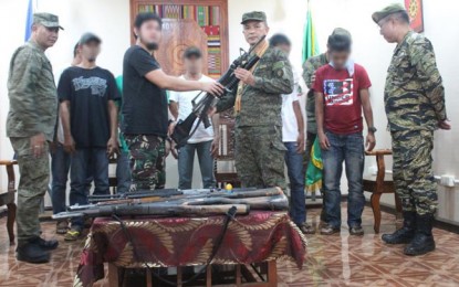 <p><strong>SURRENDER.</strong> An Abu Sayyaf surrenderer hands over a rifle to Maj. Gen. Reynaldo Aquino, Army vice commander, during his visit to the headquarters of the 1101st Infantry Brigade in Barangay Samak, Talipao, Sulu on Wednesday (Sept. 23, 2020). Eight Abu Sayyaf members have surrendered as government troops continue their focused military operation against the bandits in the hinterlands of Sulu. <em>(Photo courtesy of the Joint Task Force Sulu)</em></p>