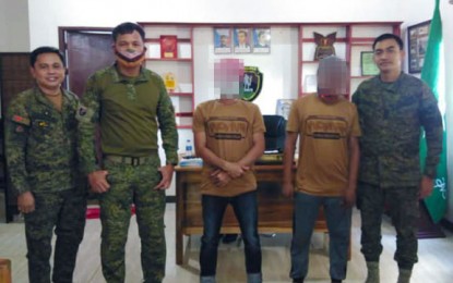 <p><strong>MORE SURRENDERERS.</strong> Two more Abu Sayyaf Group (ASG) members surrender to the military on Friday (Sept. 25, 2020) amid the latter’s continuous focused offensives against the terrorist group in Sulu province. The two are photographed with military officials led by the commander of the Army’s 6th Special Forces Battalion, Lt. Col. Rafael Caido (rightmost).<em> (Photo courtesy of the Joint Task Force Sulu)</em></p>