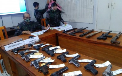 <p><strong>SURRENDERED.</strong> Personnel of the Cabanatuan City Police in Nueva Ecija conduct an accounting of registered guns in the city on Saturday (Sept. 26, 2020). Guns with unrenewed permits were surrendered for safekeeping at the police station. <em>(Photo by Marilyn Galang)</em></p>