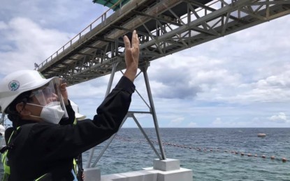 <p><strong>SITE INSPECTION</strong>. Environment Secretary Roy Cimatu surveys the conveyor of the Philippine Mining Services Corp. (PMSC) that loads dolomite to a vessel, in Barangay Pugalo in the southern town of Alcoy in Cebu on Friday (Sept. 25, 2020). Cimatu ordered the PMSC and the Dolomite Mining Corp. to temporarily suspend operations as the Department of Environment and Natural Resources investigates the alleged environmental impact of the two firms' dolomite mining activities.<em> (Photo courtesy of DENR-7)</em></p>