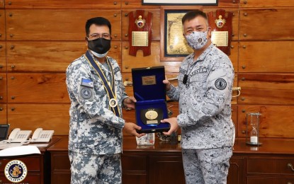 <p><strong>SUPPORT FOR NCWC.</strong> Navy chief, Vice Admiral Giovanni Carlo Bacordo (right), presents a token of appreciation to National Coast Watch Center chief, Commodore Roy Echeverria (left), during a courtesy call at the Navy headquarters in Manila on Monday (Sept. 28, 2020). The Navy vowed its full support to the NCWC in protecting the country's maritime interests.<em> (Photo courtesy of the Naval Public Affairs Office)</em></p>