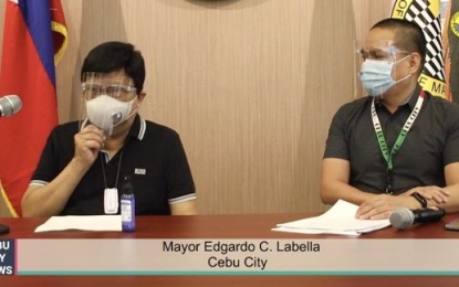 <p><strong>ONLINE PERMIT APPLICATION</strong>. Mayor Edgardo Labella (left) and Office of the Building Official chief Florante Catalan announce the online processing of building and occupancy permit to operationalize Republic Act 11032 or the Ease of Doing Business and Efficient Government Service Delivery Act of 2018 during a press briefing at the Cebu City Hall on Tuesday (Sept. 29, 2020). The application for business and occupancy permits as well as payment to the OBO can be done online starting Oct. 1<em>. (Screengrab from Cebu City Hall PIO)</em></p>