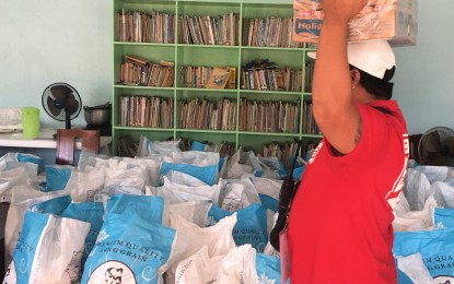 <p><strong>PANDEMIC RESPONSE</strong>. An undated photo shows an official of Barangay Bato in Toledo City, Cebu helps unpack relief goods for residents, which the community bought using its direct financial benefits from AboitizPower subsidiary Therma Visayas, Inc. (TVI) under the ER 1-94 program. The program provides that host communities are entitled to PHP0.01 per kilowatt-hour of the total electricity sales of the energy companies. Their shares should be used for financing electrification, livelihood, and development projects, such as reforestation, watershed management, health, and environmental enhancement initiatives. <em>(Photo courtesy of AboitizPower)</em></p>
<p> </p>