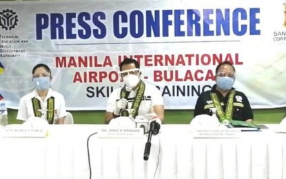 <p><strong>SKILLS TRAINING</strong>. Bulacan Governor Daniel Fernando (center), lawyer Micaela Rosales of San Miguel Corporation (left) and TESDA Regional Director Jesus Fajardo (right) are shown during a press conference after the launching of SMC's free livelihood and skills training program for Bulacan residents at the Regional Training Center in Guiguinto, Bulacan Wednesday (Sept. 30, 2020). The initial beneficiaries of the training program were 60 former residents of Barangay Taliptip in Bulakan town, who have accepted the relocation offer of SMC for the construction of its PHP734-billion New Manila International Airport<em>. (Photo courtesy of TESDA Bulacan)</em></p>