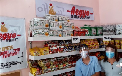 <p><strong>KOREAN MINI-MART</strong>. Reymart Simba and Ashley Sornillo work as storekeepers of Aegyo Korean Minimart put up by a fresh civil engineering graduate in July this year.  Thomas Jason Ferrer, 21, said the coronavirus pandemic has prompted him to open the Korean store while waiting for his postponed board exam. <em>(Thomas Jason’s photo)</em></p>