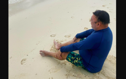 <p>Presidential Spokesperson Harry Roque sits on Boracay's white sandy shores on Sunday (Oct. 4, 2020).</p>