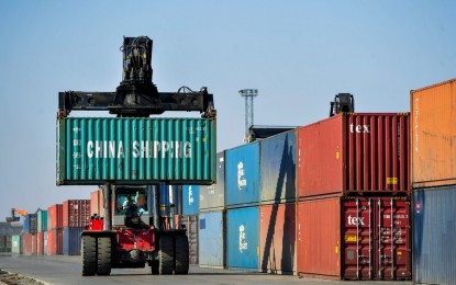 <p><strong>TRADE DECLINE.</strong> A crane loads containers at Erenhot Port in north China's Inner Mongolia Autonomous Region on April 11, 2020. According to the World Trade Organization, world merchandise trade is expected to fall by 9.2 percent in 2020, followed by a 7.2-percent rise in 2021. <em>(Lian Zhen/Xinhua photo)</em></p>