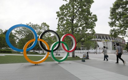 <p><strong>OLYMPIC RINGS</strong>. Photo taken on June 12, 2020, shows the Olympic rings and a part of the new National Stadium, the main venue for the Tokyo Olympics and Paralympics, in Tokyo, Japan. World Athletics President Sebastian Coe on Thursday (Oct. 8, 2020) said Tokyo will host a fantastic Olympic Games despite the uncertainties amid the coronavirus pandemic. <em>(Xinhua/Du Xiaoyi)</em></p>