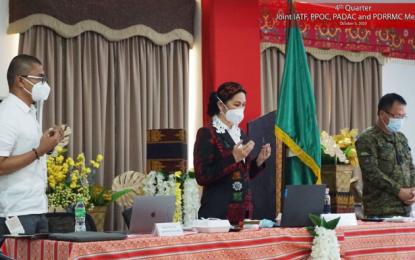 <p><strong>PEACE AND ORDER MEETING.</strong> Maguindanao Governor Mariam Sangki-Mangudadatu (center) leads the prayer prior to the start of the local peace and order council meeting in Maguindanao attended by officials of the Army’s 6th Infantry Division (ID) in Buluan, Maguindanao on Thursday (Oct. 8, 2020). During the meeting, Maj. Gen. Juvymax Uy, the 6ID chief (right), posed a challenge to the town mayors to help put an end to violent extremism in the province. <em>(Photo courtesy of Maguindanao PIO)</em></p>