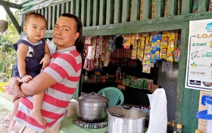 <p><strong>SMALL BUSINESS</strong>. Repatriated overseas Filipino worker (OFW) Prime Villariasa, along with her one-year-old child, pose at their 'sari-sari' store. Villariasa engaged in small business due to the coronavirus pandemic. <em>(Photo courtesy of Rhona Villariasa)</em></p>