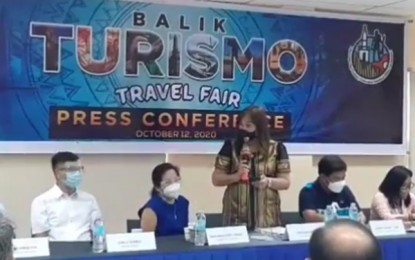 <p><strong>TRAVEL FAIR</strong>. Tourism, Cultural and Historical Affairs Commission (TCHAC) chairperson Cynthia King-Chan (center, standing) speaks during the launching of the Balik Turismo Travel Fair on Monday (Oct. 12, 2020) at the Lapu-Lapu City Hall. The travel fair, which will take place on Oct. 17, 2020, is one of the major activities slated to help revive Mactan’s tourism industry. <em>(Screengrab from Lapu-Lapu City Hall PIO video)</em></p>