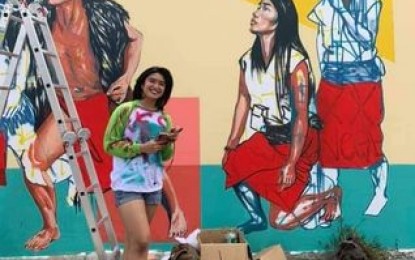 <p><strong>RESTORATION WORK</strong>. Artist Venazir Martinez poses in front of her work which was vandalized last Oct. 10. The mural was restored in September this year with funds coming from the National Commission for Culture and the Arts. (<em>Photo was taken from the Facebook page of Venazir Martinez</em>) </p>